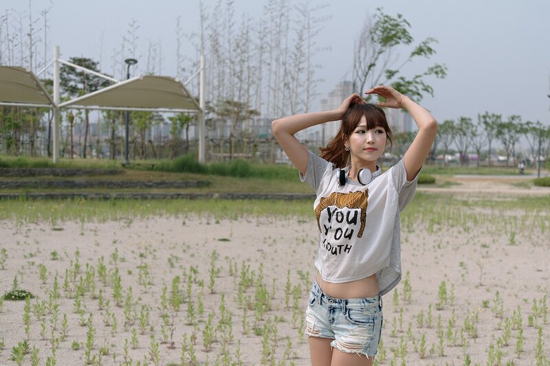 Woman in park with headphones