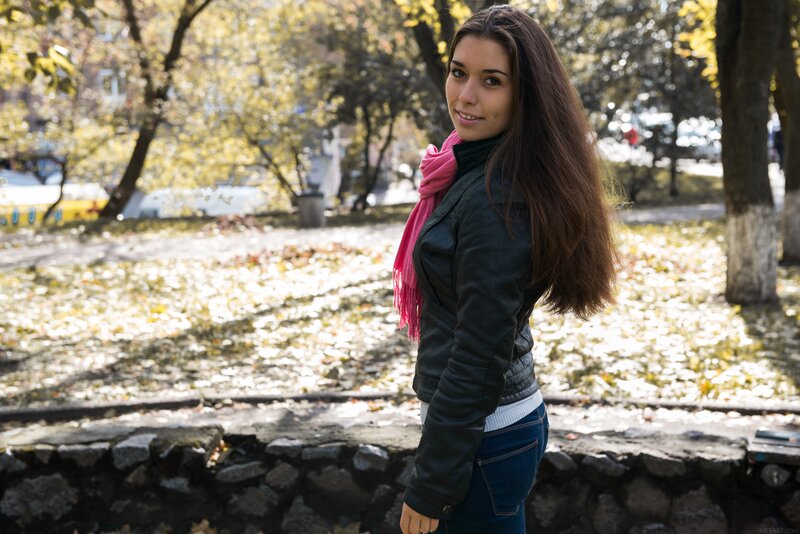 Woman in park with pink scarf