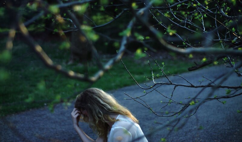 woman in park with trees