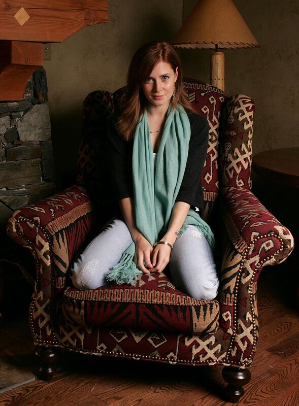 woman in patterned armchair
