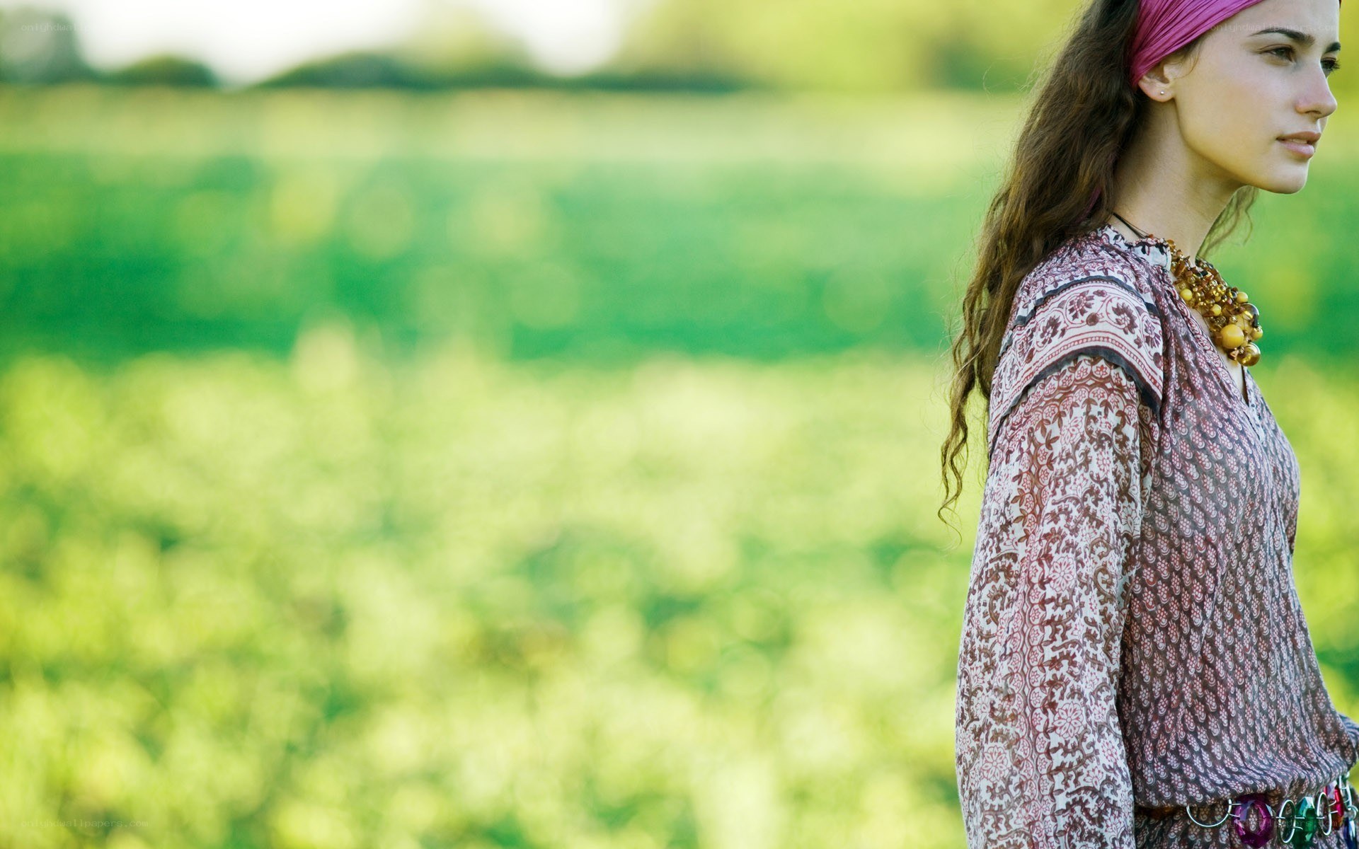 woman in patterned blouse outdoors