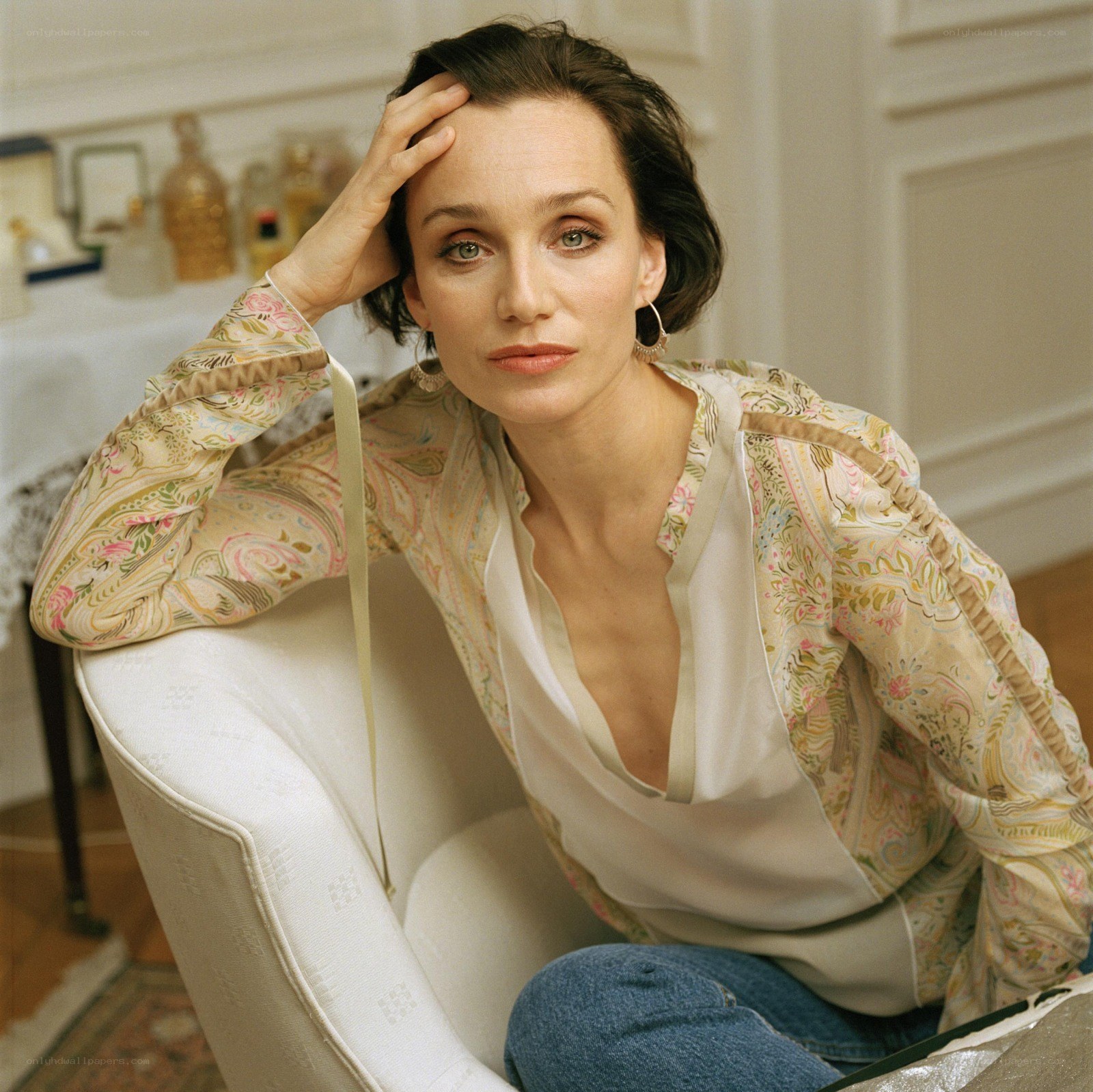 woman in patterned blouse sitting
