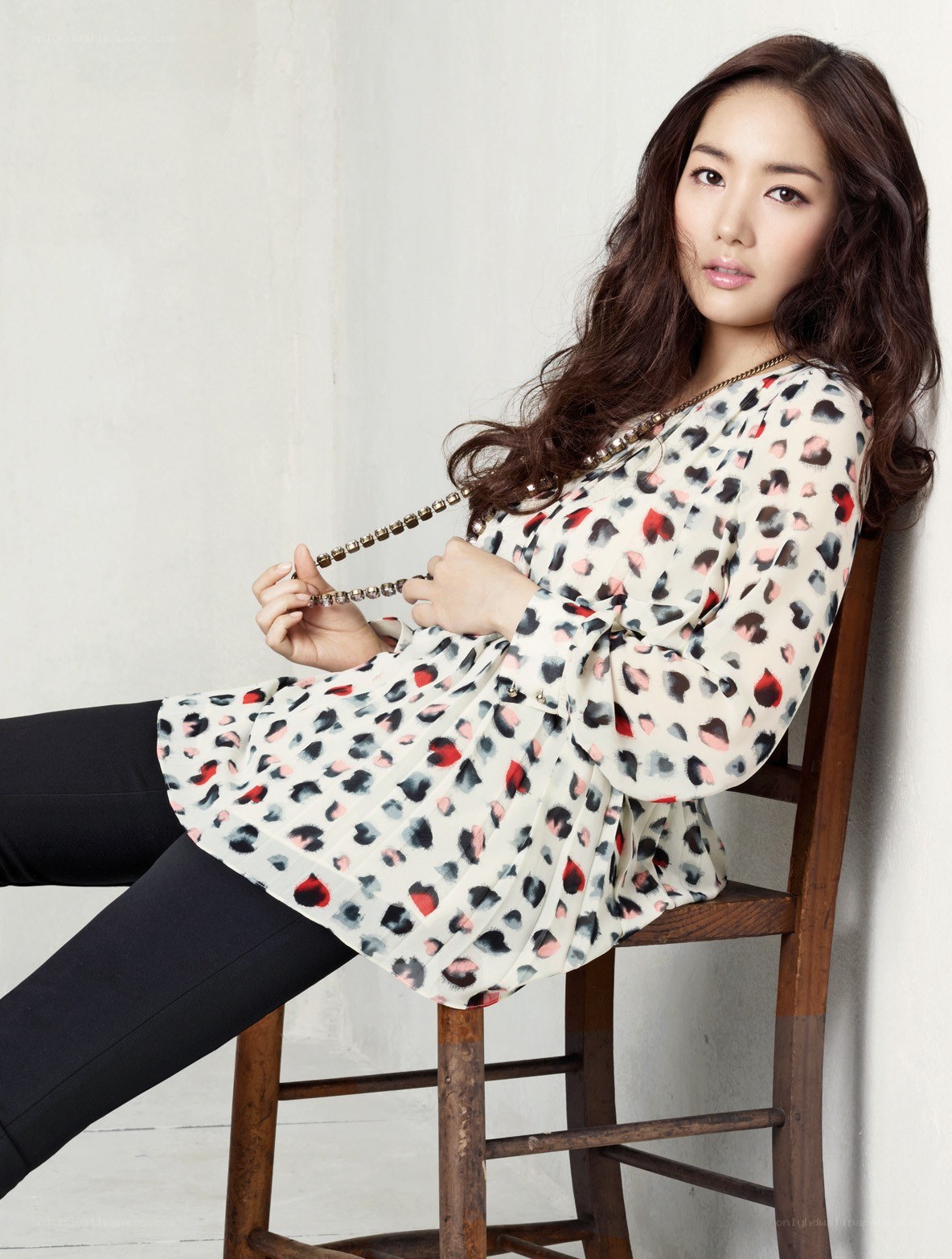 woman in patterned blouse sitting