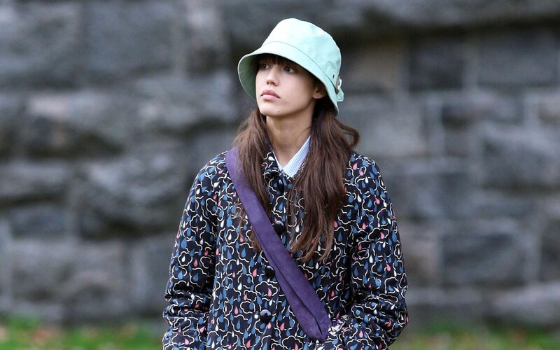 woman in patterned coat and hat
