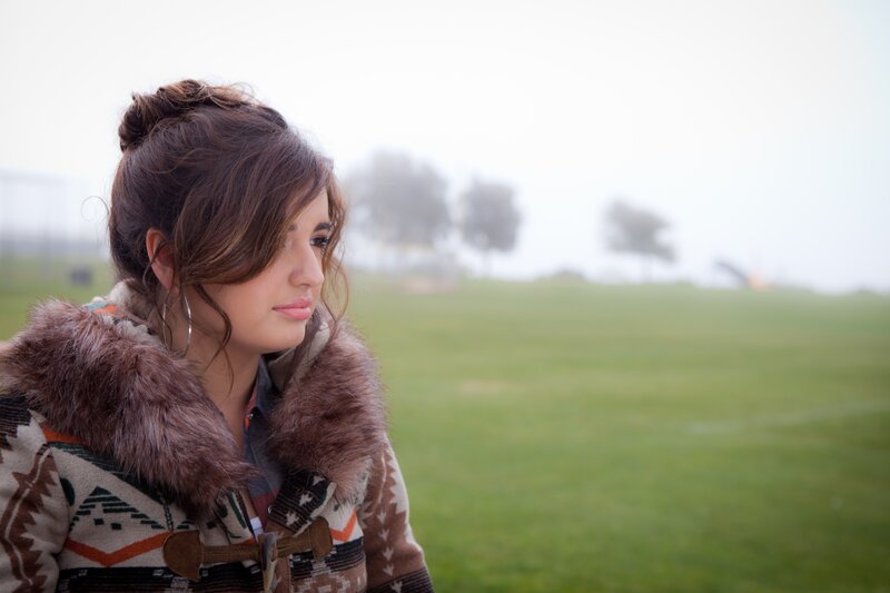 Woman in Patterned Coat — Brown, Contemplative