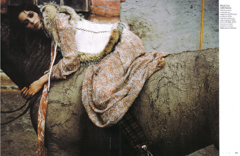 Woman in patterned coat on horse