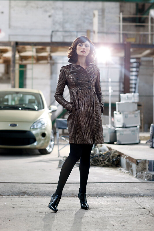 Woman in patterned coat standing