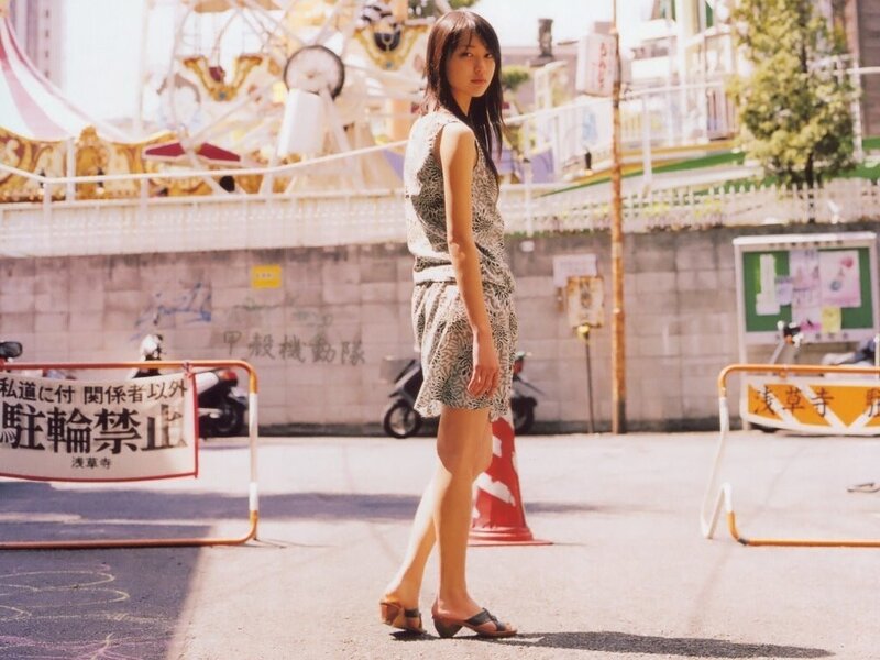 Woman in patterned dress at amusement park