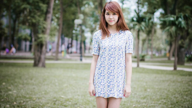 Woman in patterned dress at park