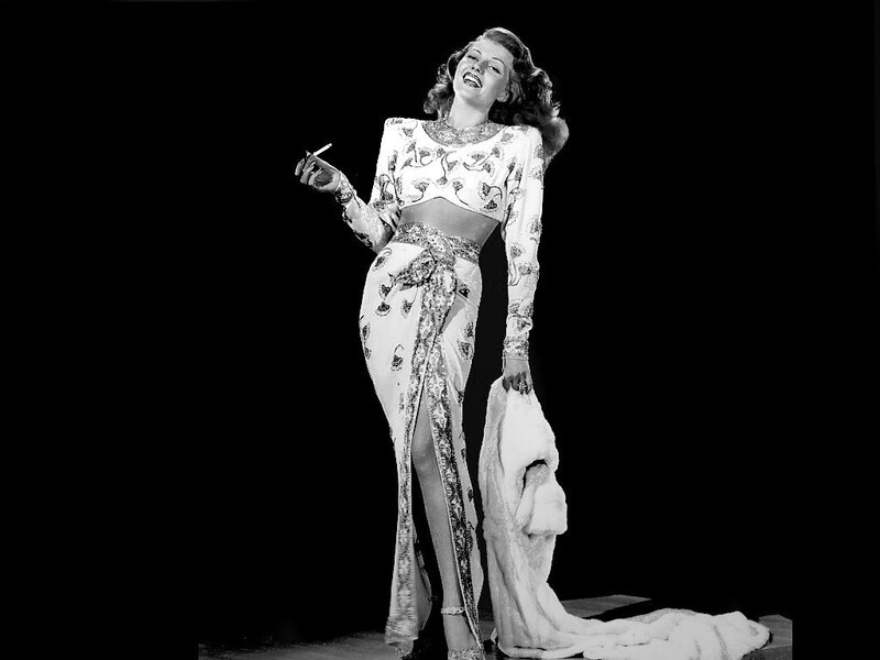 Woman in patterned dress holding cigarette