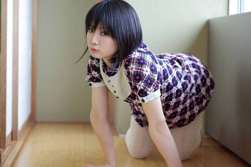woman in patterned dress kneeling