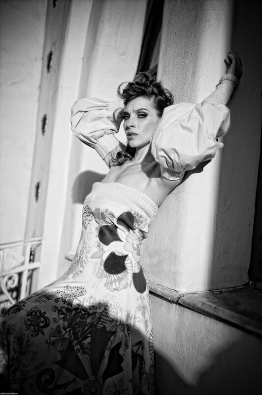 woman in patterned dress leaning