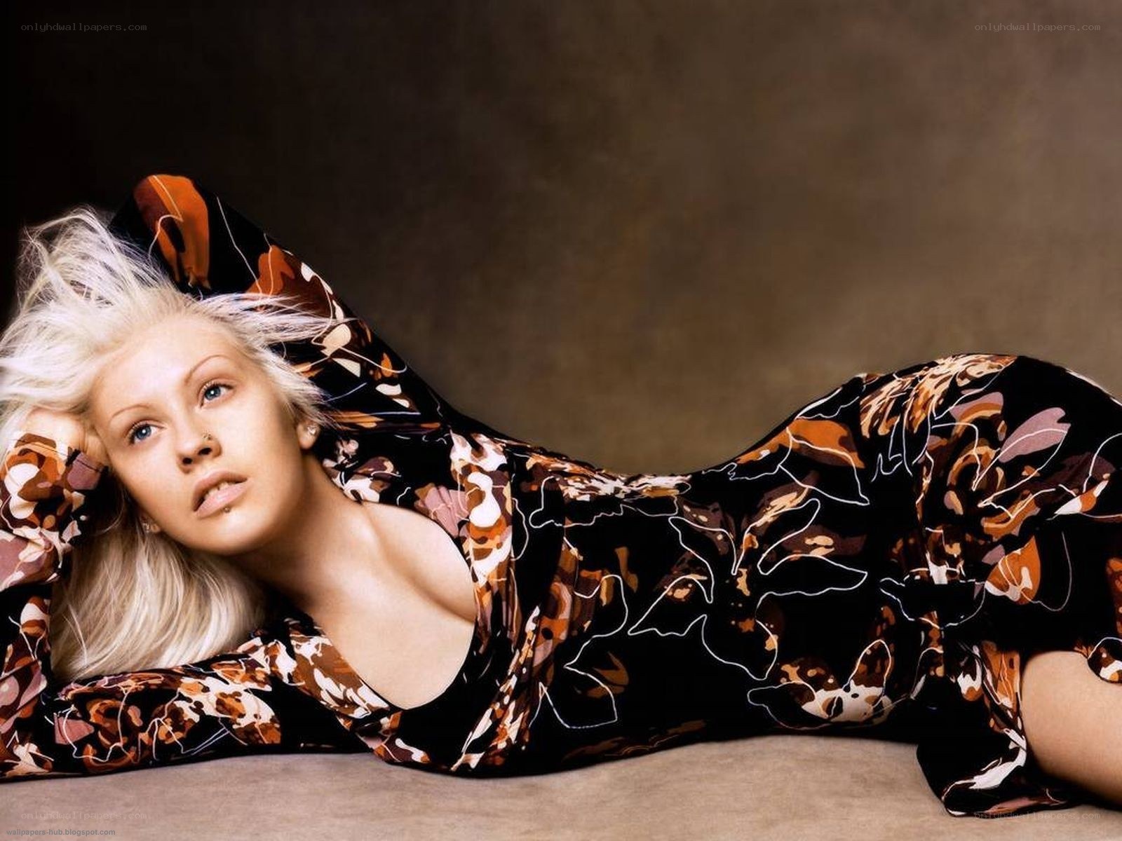 woman in patterned dress lying down
