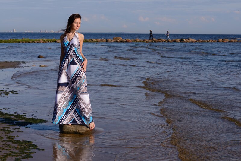 Woman in patterned dress on beach