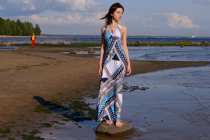 Woman in patterned dress on beach