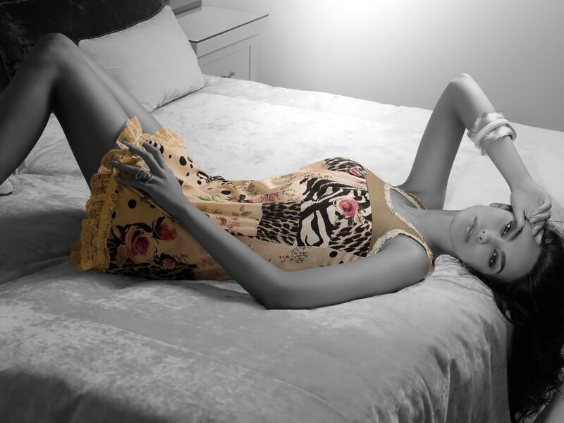woman in patterned dress on bed