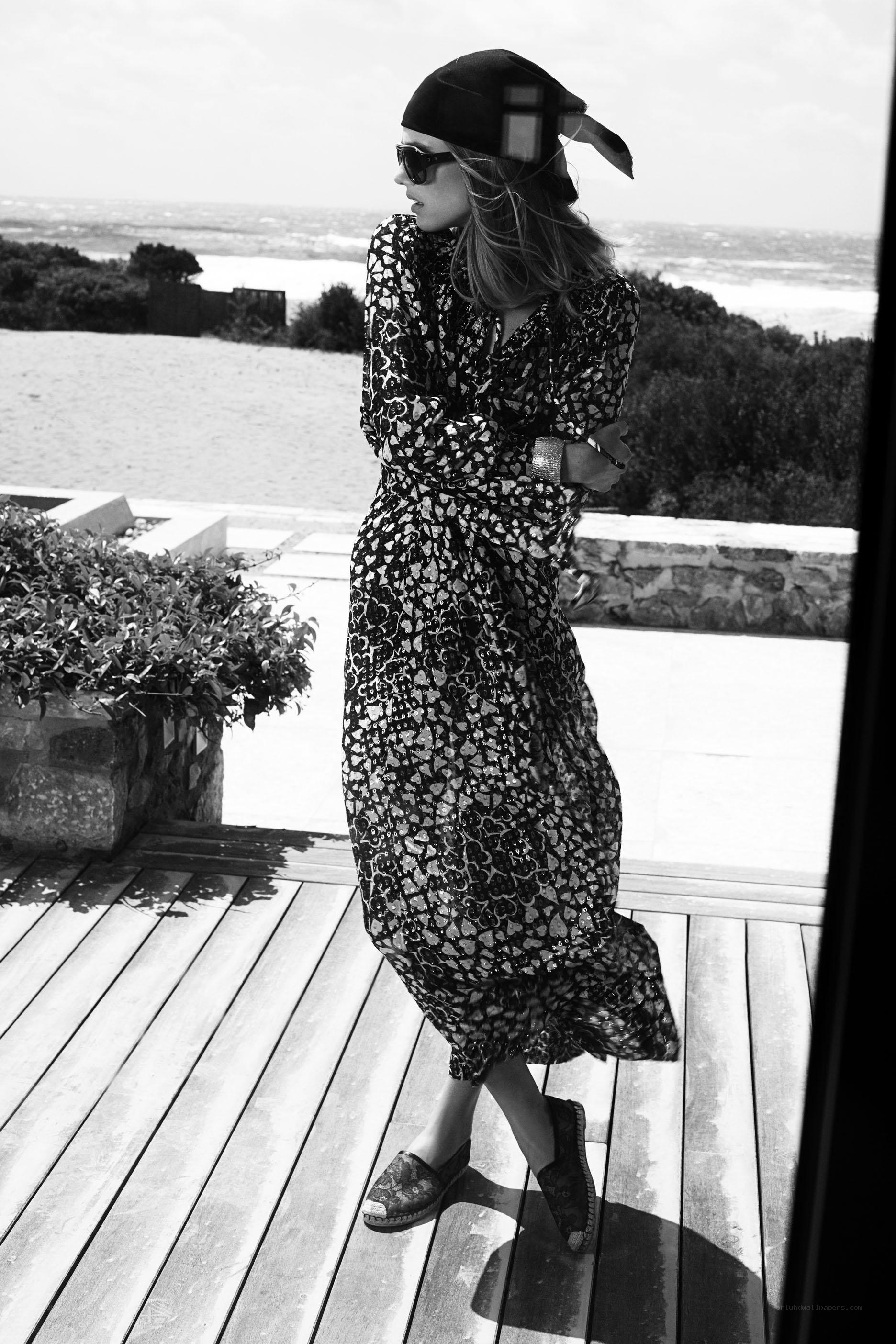 Woman in patterned dress on deck