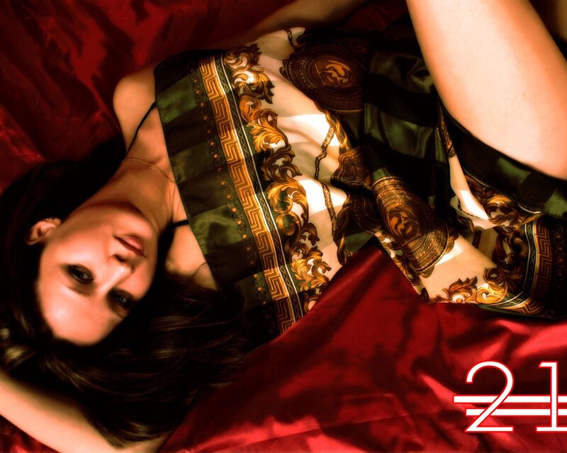 woman in patterned dress on red fabric