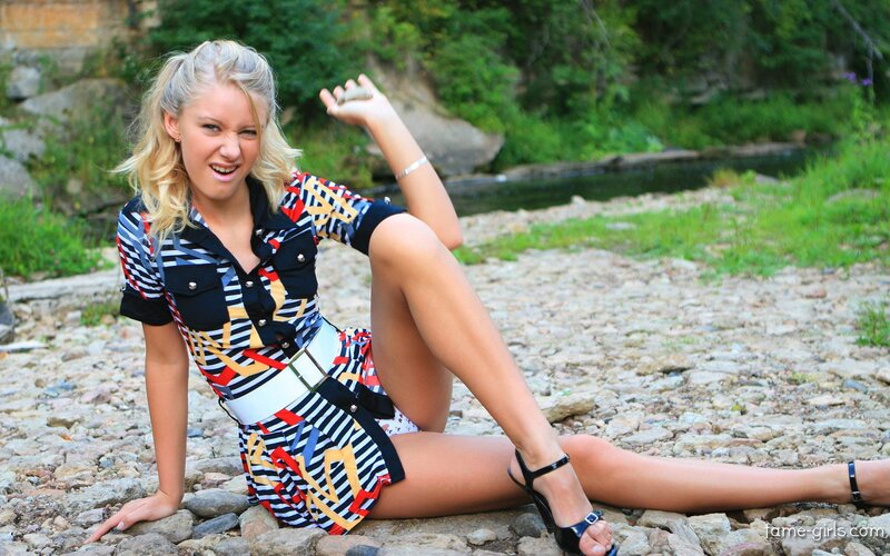 Woman in patterned dress on riverbank