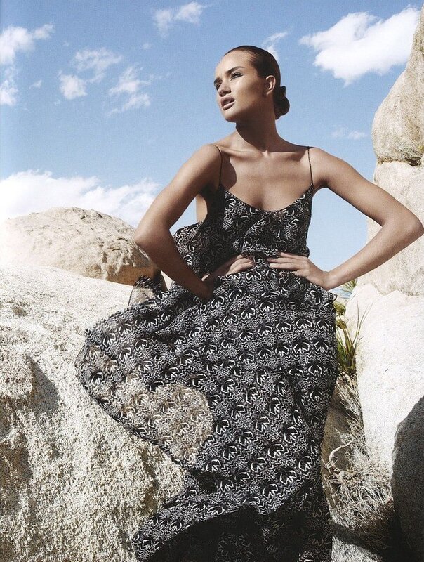 Woman in patterned dress on rocks