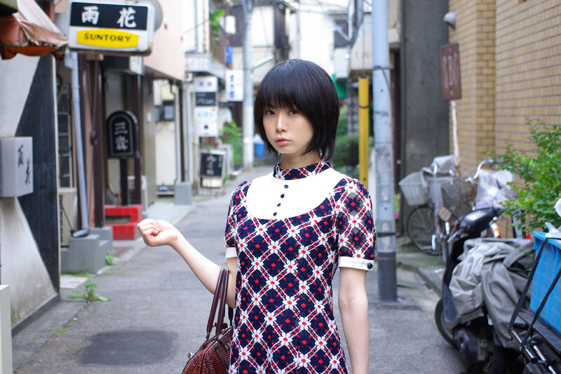 woman in patterned dress on street