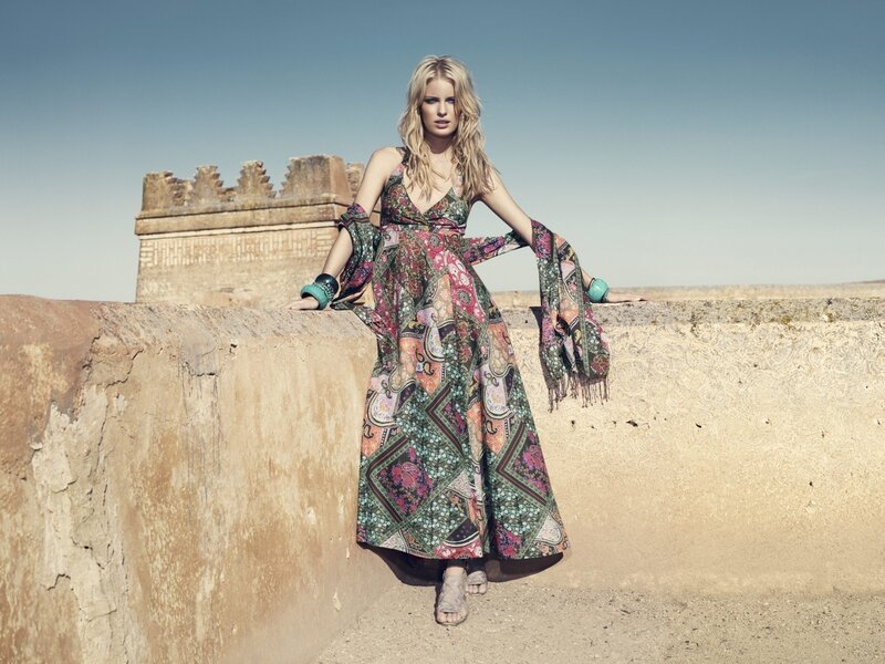 woman in patterned dress on wall