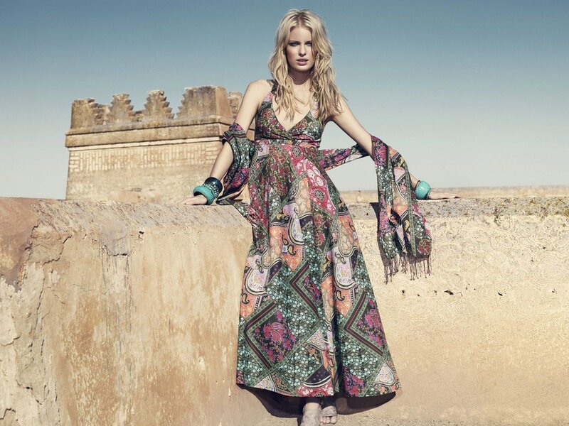 Woman in patterned dress on wall