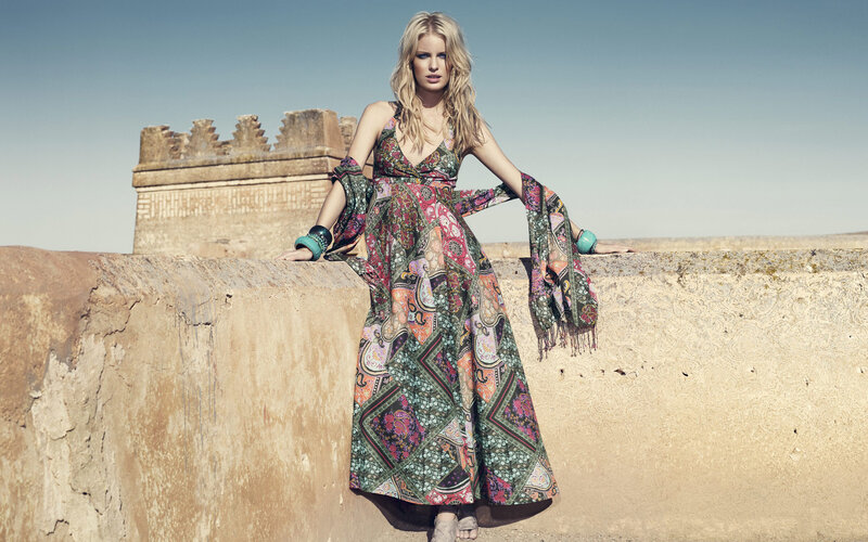 woman in patterned dress on wall