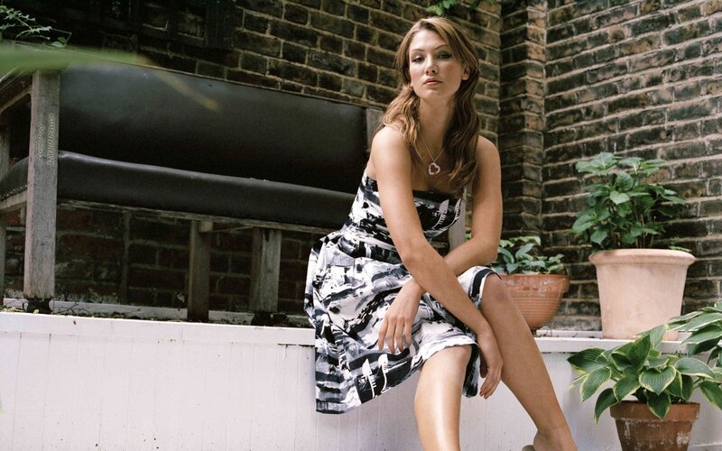 woman in patterned dress sitting