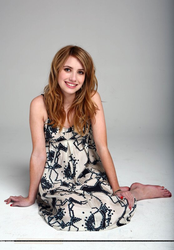woman in patterned dress sitting