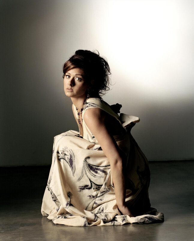 woman in patterned dress sitting