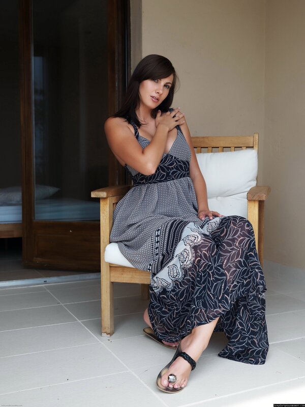 Woman in patterned dress sitting