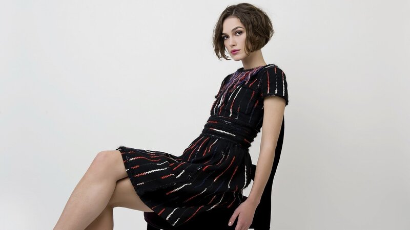 woman in patterned dress sitting