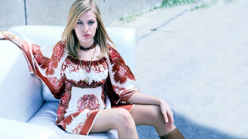 woman in patterned dress sitting