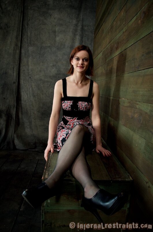 woman in patterned dress sitting