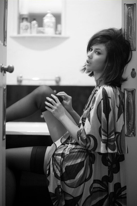 woman in patterned dress sitting
