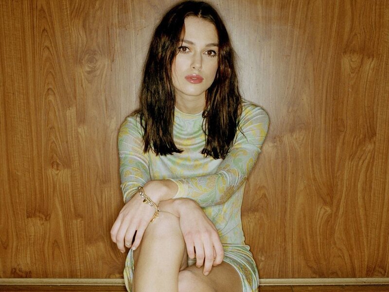 woman in patterned dress sitting