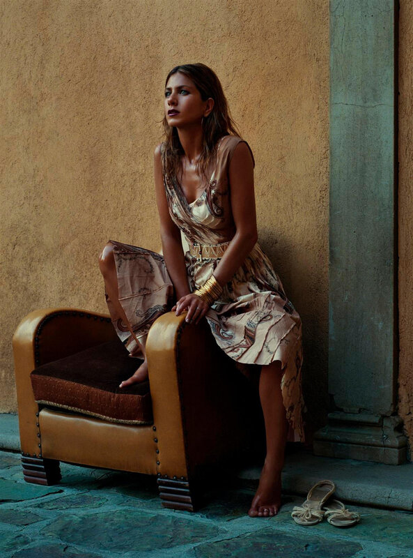 woman in patterned dress sitting