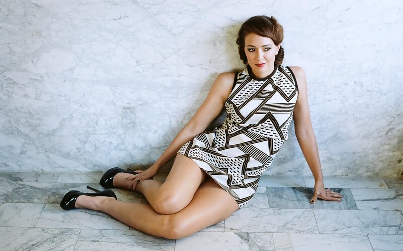 woman in patterned dress sitting on floor