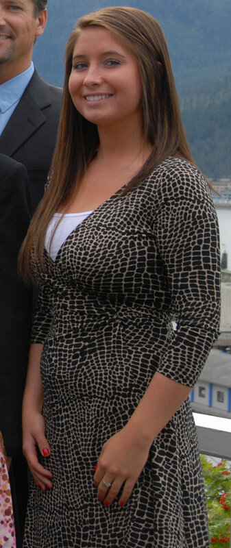 Woman in patterned dress smiling