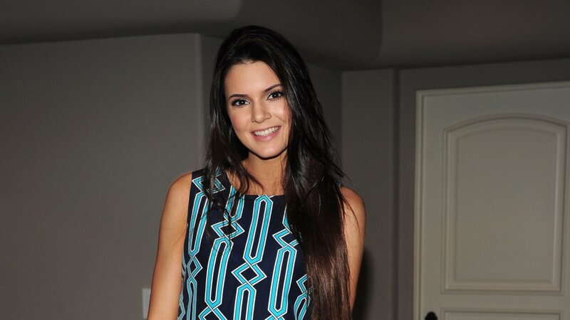 woman in patterned dress smiling