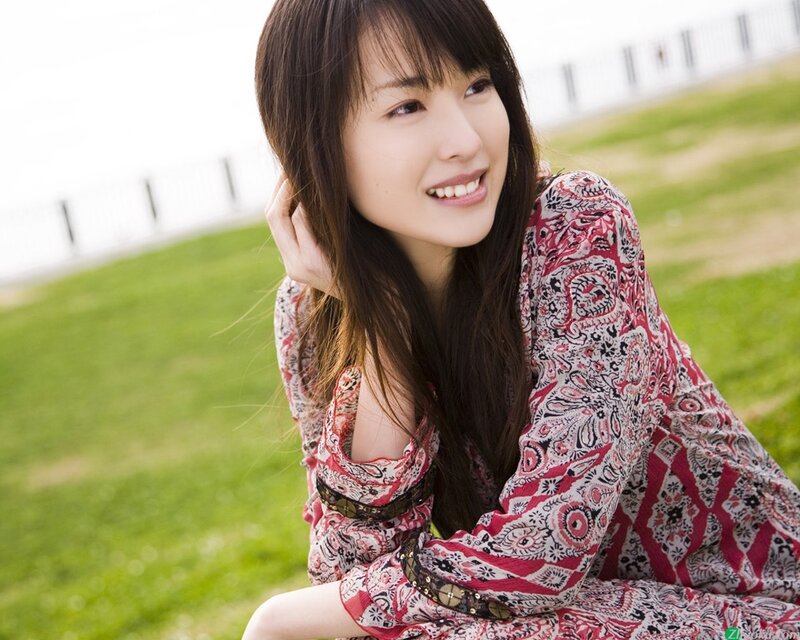 woman in patterned dress smiling