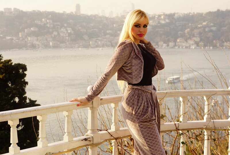 Woman in patterned outfit by the water