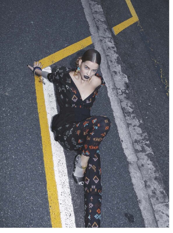 woman in patterned outfit on street