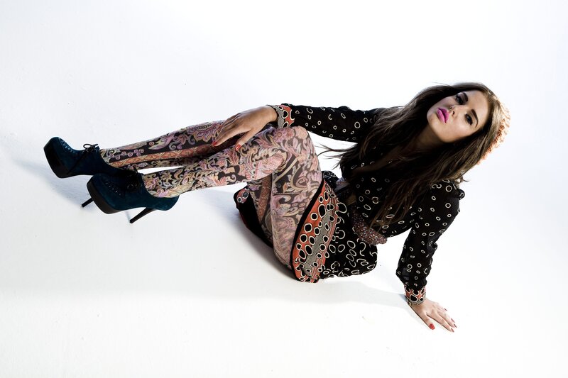 woman in patterned outfit posing