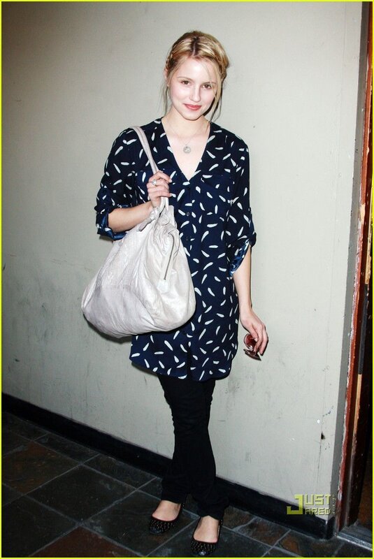 woman in patterned shirt holding bag