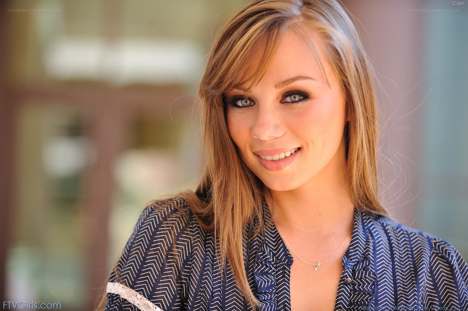woman in patterned shirt smiling