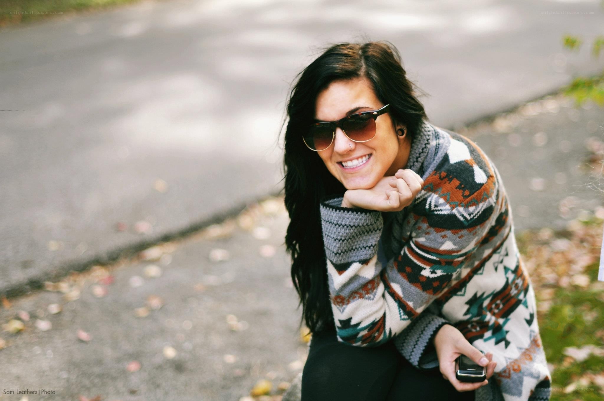 woman in patterned sweater smiling