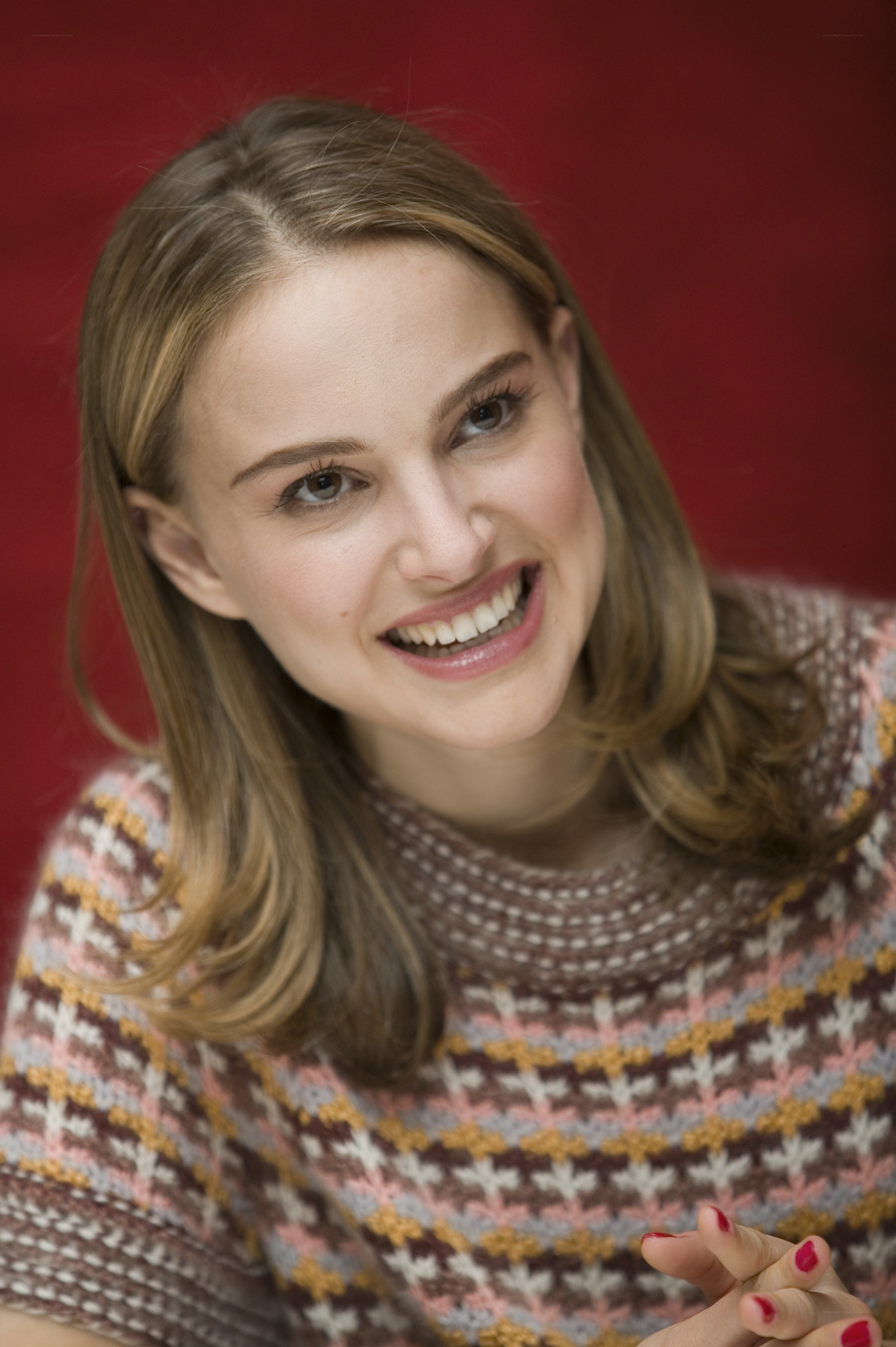 woman in patterned sweater smiling