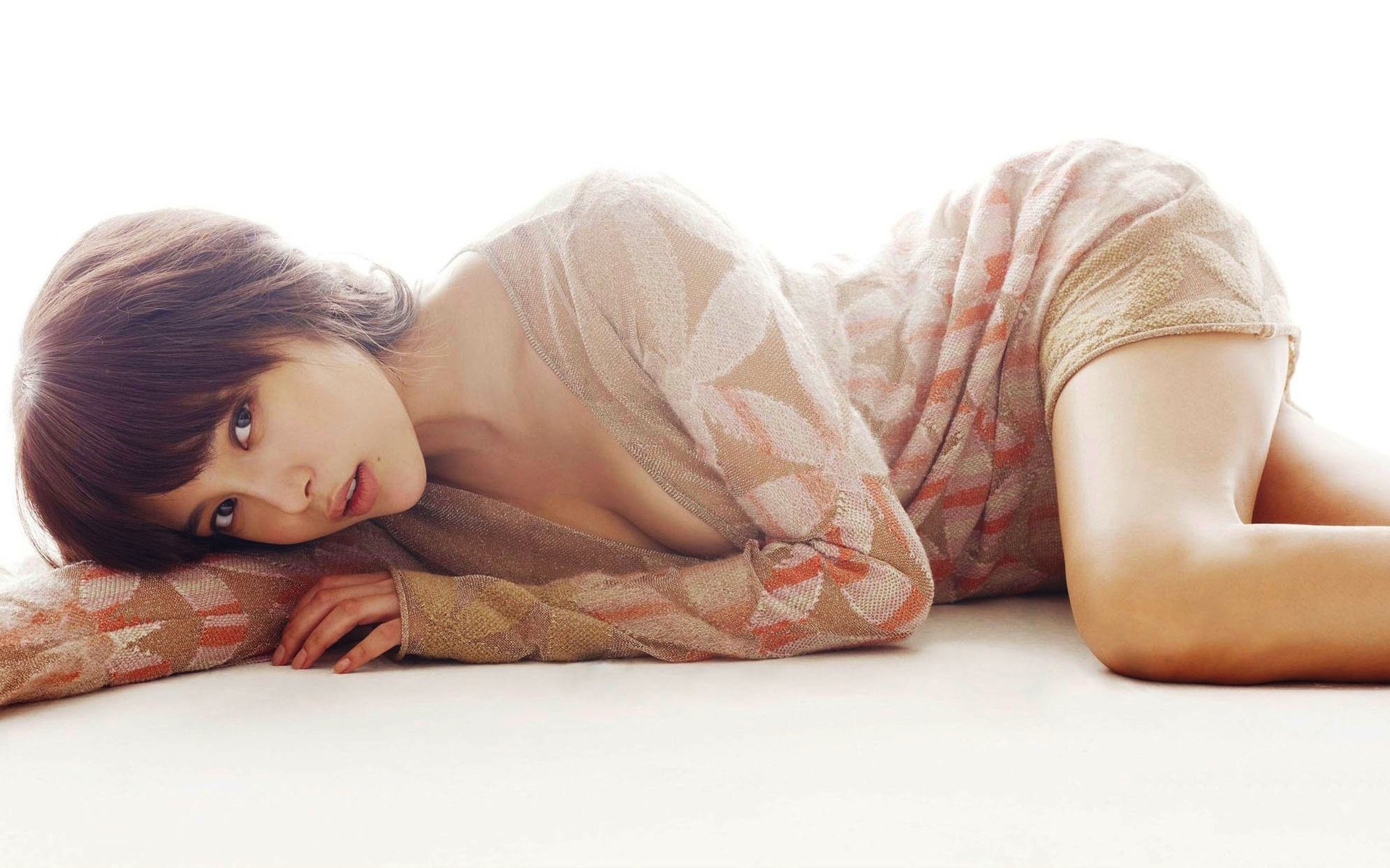 woman in patterned top lying down